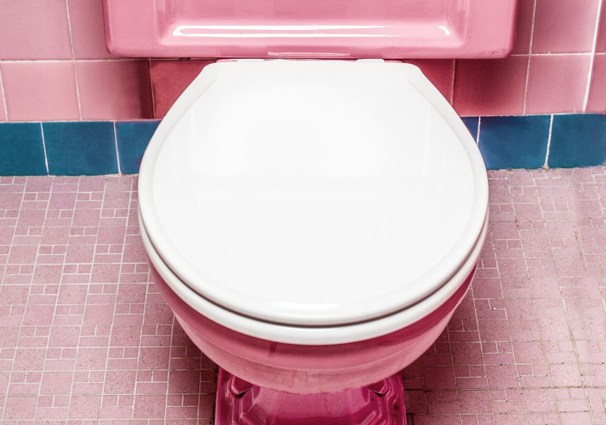 pink and white ceramic toilet bowl