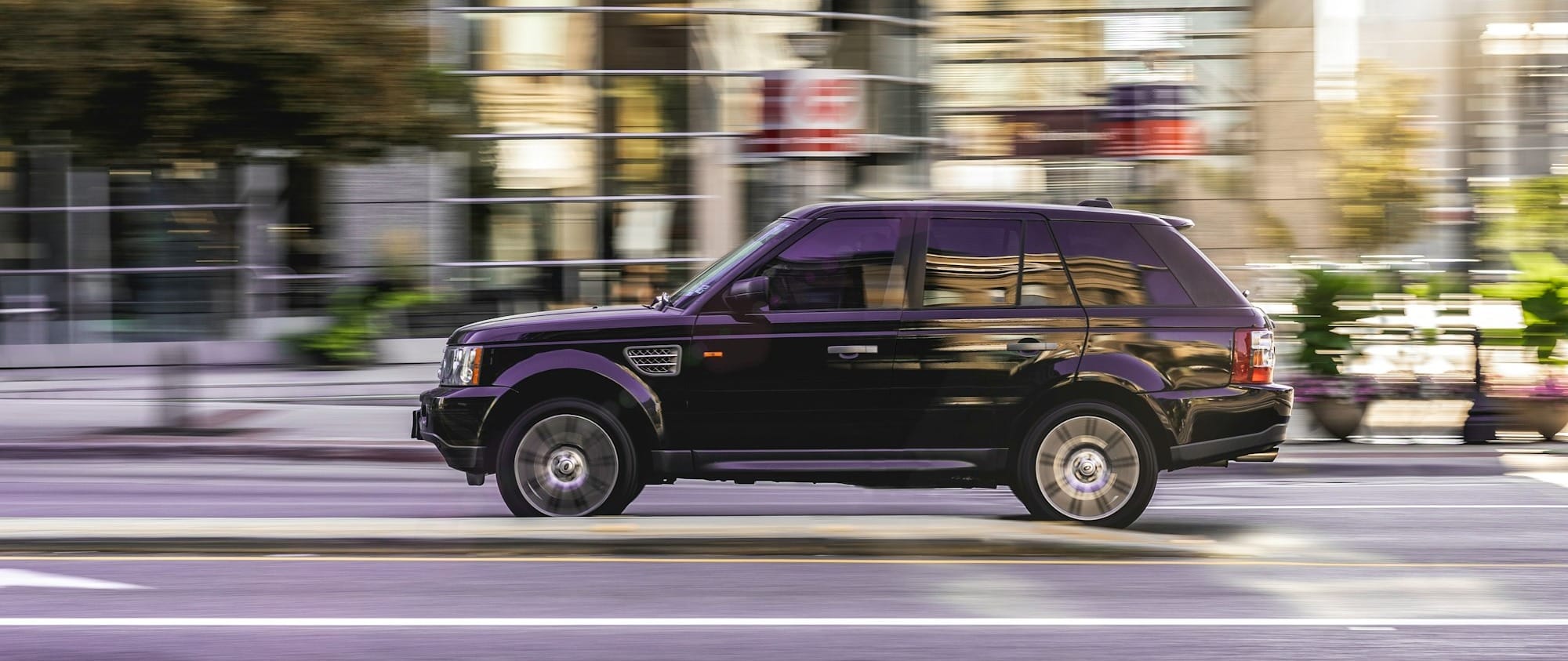 black suv on road during daytime